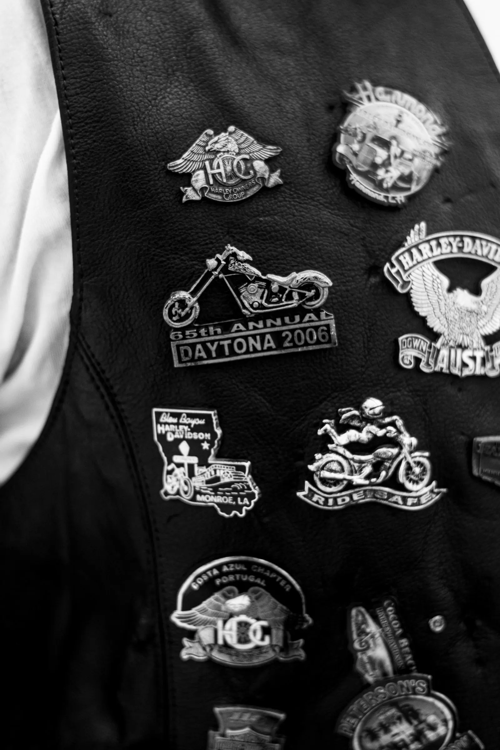 Leather vest covered in biker patches and pins