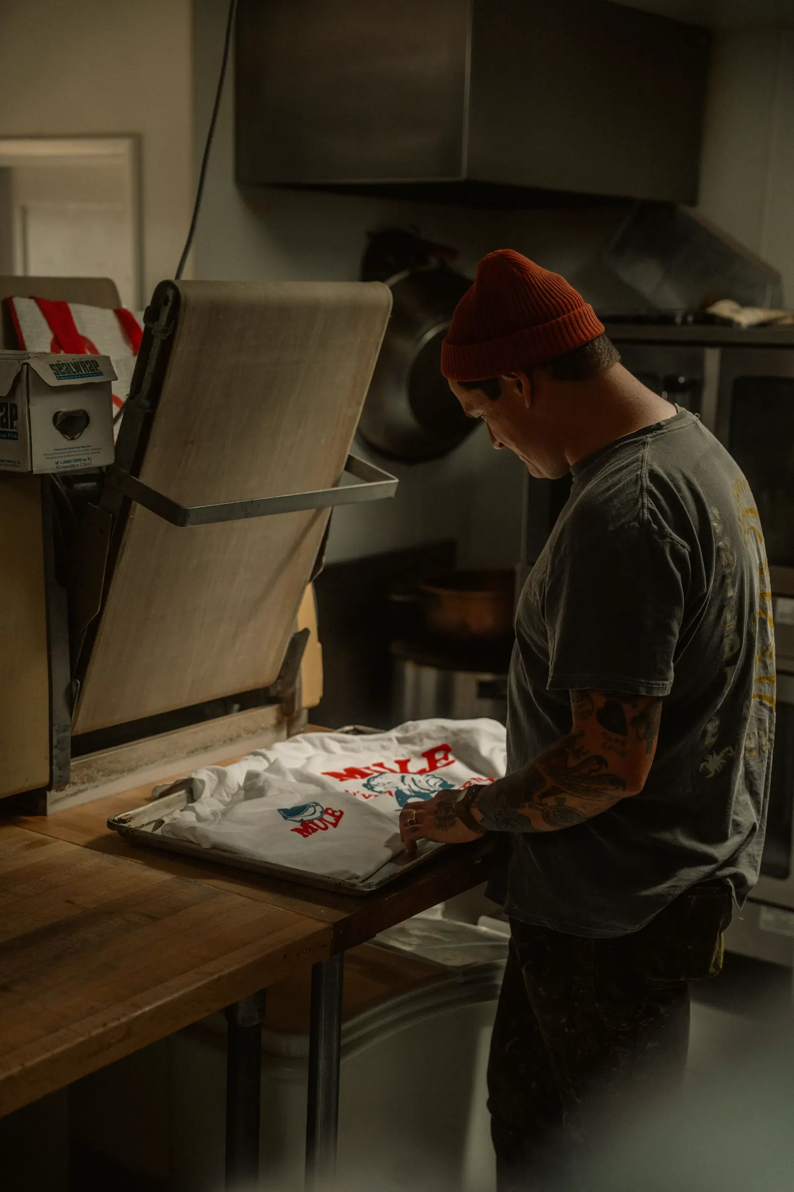 Printer lining up a T-shirt in the shop